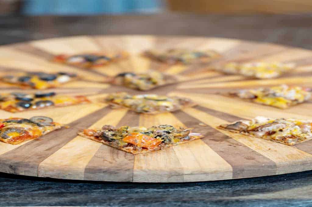 close-up of slices of pizza made with wheat tortilla served on a wooden board